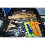 A box containing various cutlery and kitchen utens