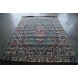 An approx. 9'6" x 6'9" green patterned rug