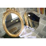 A frameless bevel edge mirror and an ornate gilt f