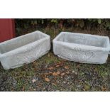 A pair of concrete garden planters