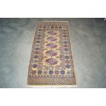 An approx. 4'7" x 2'3" patterned rug