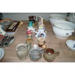 A collection of pottery and porcelain jugs etc.