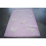 An approx. 3' x 5'10" pink rug