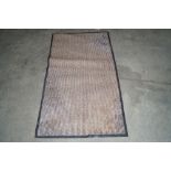 An approx. 4'11" x 2'8" door mat