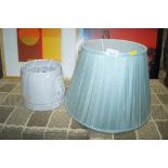 A blue lamp shade together with a pair of lamp sha