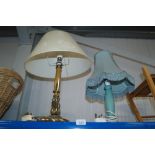 A brass table lamp and a wooden table lamp