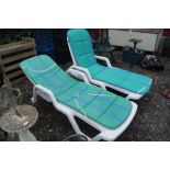 Two plastic garden loungers