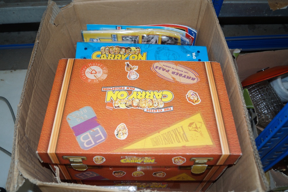 A box containing Carry On DVDs and ephemera