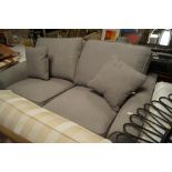 A grey upholstered two seater sofa bed
