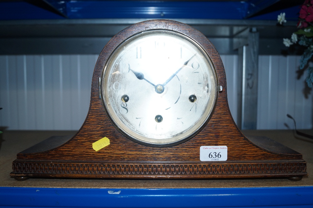An oak cased three hole mantel clock