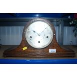 An oak cased three hole mantel clock