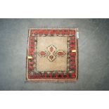 An approx. 1' square patterned rug