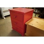 A painted bedside chest, fitted three drawers