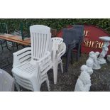 Seven various white plastic chairs and seven black