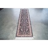 An approx. 9'7" x 2'4" floral patterned rug