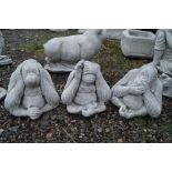 Three garden ornaments in the form of monkeys