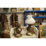 Two brass oil lamps on adjustable stands