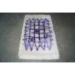 An approx. 4'2" x 2'6" wool rug