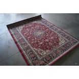 An approx. 7'7" x 5'8" red patterned rug