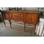 A reproduction mahogany serpentine front sideboard