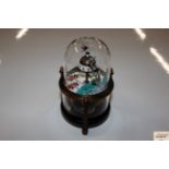 A wind-up musical fish clock contained in glass do