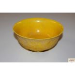 A yellow Chinese rice bowl with dragon decoration