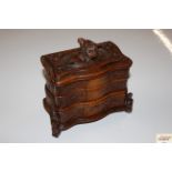 A carved oak trinket box, having floral carved dec