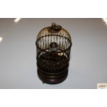 A wind-up musical bird cage clock