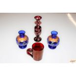 A ruby glass mug; a ruby glass baluster vase; and