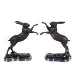 A pair of bronze boxing hares, 30cm high