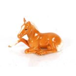 A Beswick figure of a lying Palomino foal Serial N