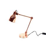 A pair of copper angle poise type desk lamps