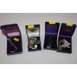 A box containing four boxed necklaces