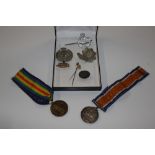 A case containing two WW1 medals, a WW1 artillery