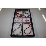 A tray of hand made jewellery