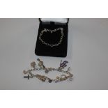 A Sterling silver charm bracelet and one other rol