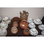 Five terracotta pots and a jug