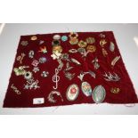 A quantity of various costume brooches
