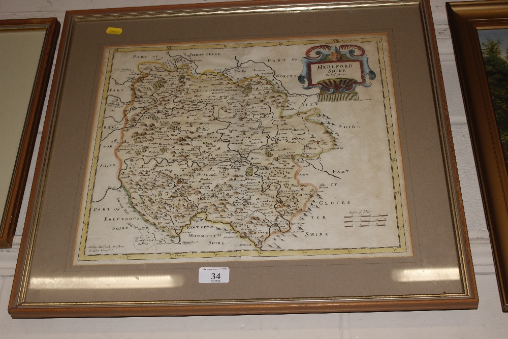 A framed and glazed hand coloured map of Herefords