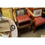 An oak elbow chair and small foot stool