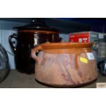 Two pottery cooking pots with lids