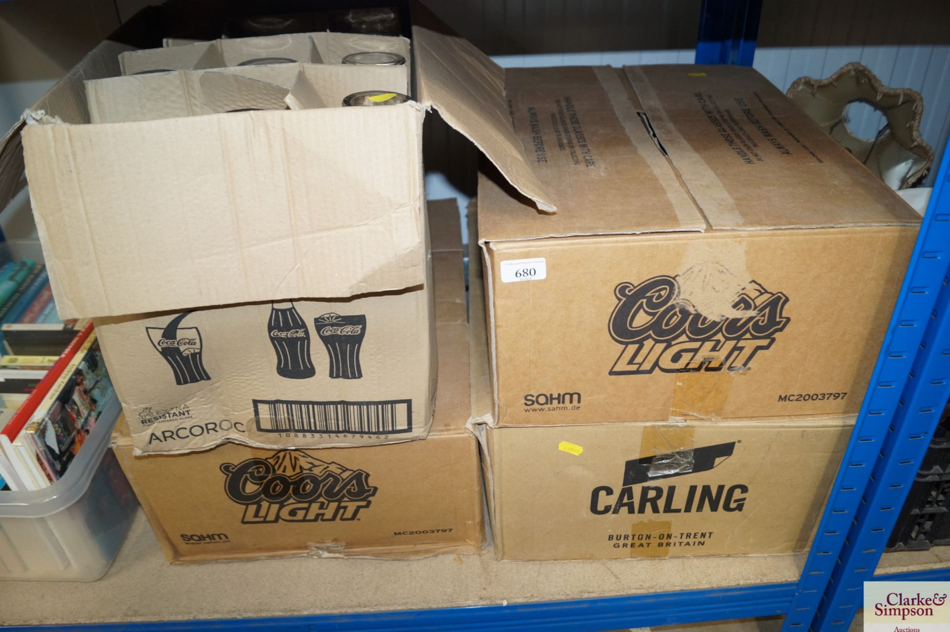 Four boxes of Carling, Coca-Cola and Kors Light gl