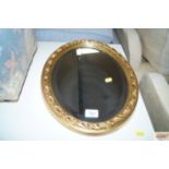 An oval gilt framed and bevel edge wall mirror