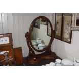 A Victorian walnut swing framed mirror