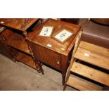 A mahogany side cupboard raised on turned tapering