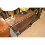 An antique oak gate leg table