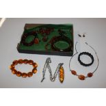 A tray of various amber and faux amber jewellery