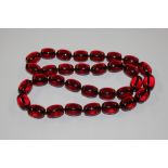 A string of cherry amber coloured beads