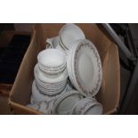 A box of various Pyrex bowls, plates and cookware