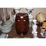 A large brown glazed stoneware water urn with wood